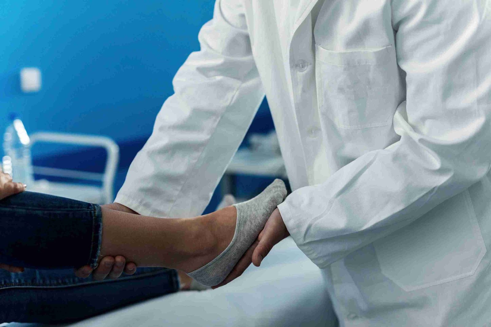 Close-up of a Lakeside podiatrist performing a physical foot exam in a clinical office.