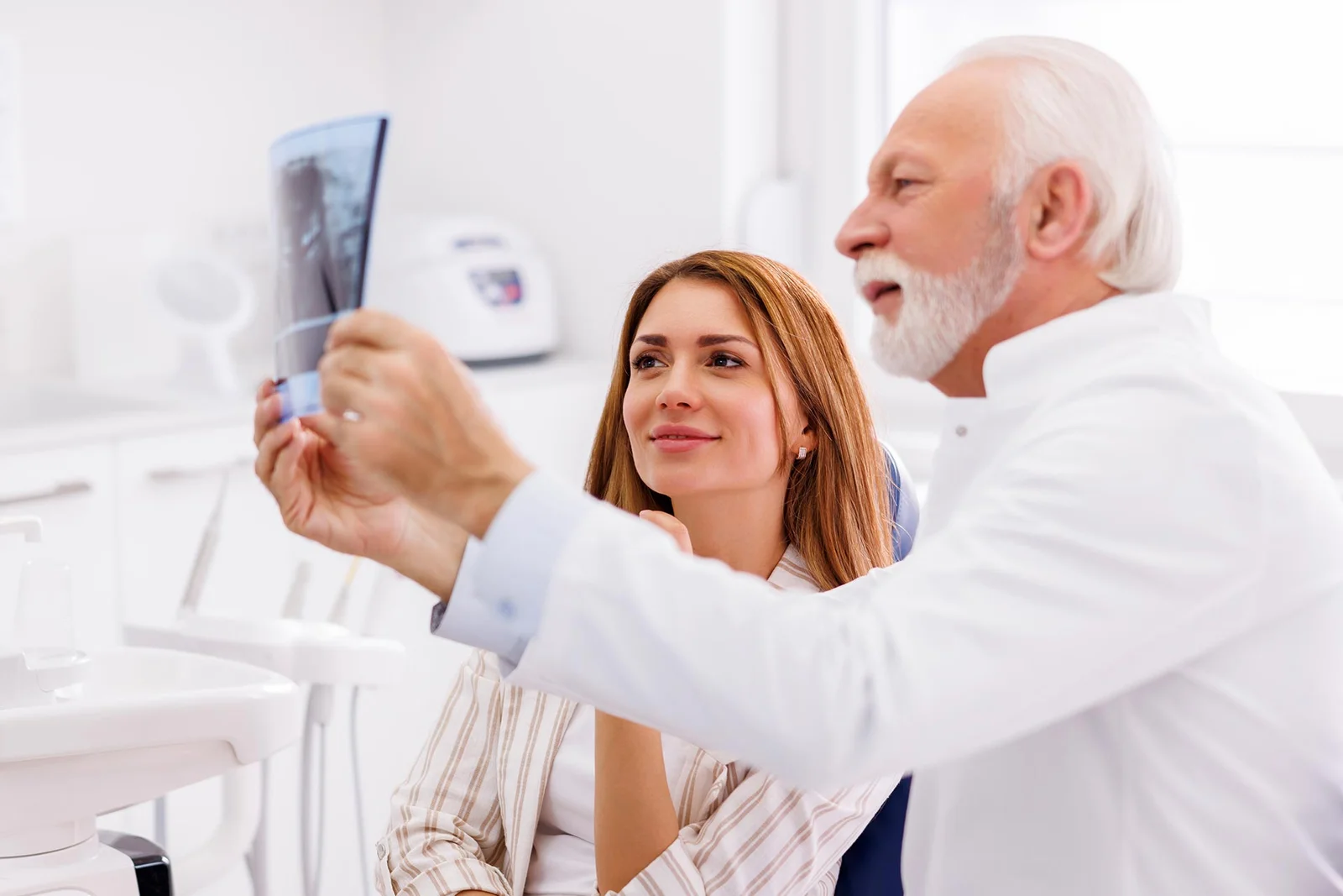 A podiatrist reviews a diagnostic X-ray with a patient to discuss treatment options.