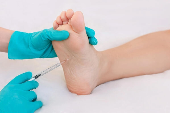 Podiatrist administering a PRP injection into the heel of a patient's foot to support natural healing at Lakeside Foot and Ankle Center in Central Florida