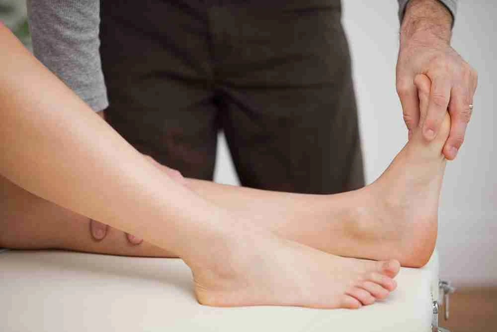 Therapist examining patient’s foot for Liposana injection therapy at Lakeside Foot and Ankle
