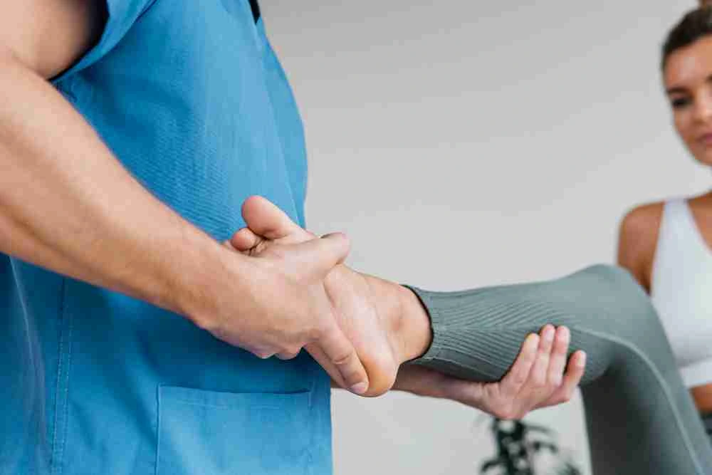 Medical professional stretching patient’s leg during Liposana recovery session across Central Florida